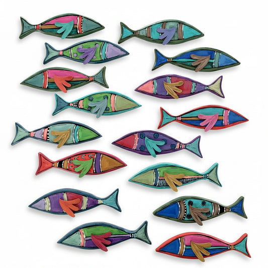 Colorful fish-shaped objects on a wooden surface