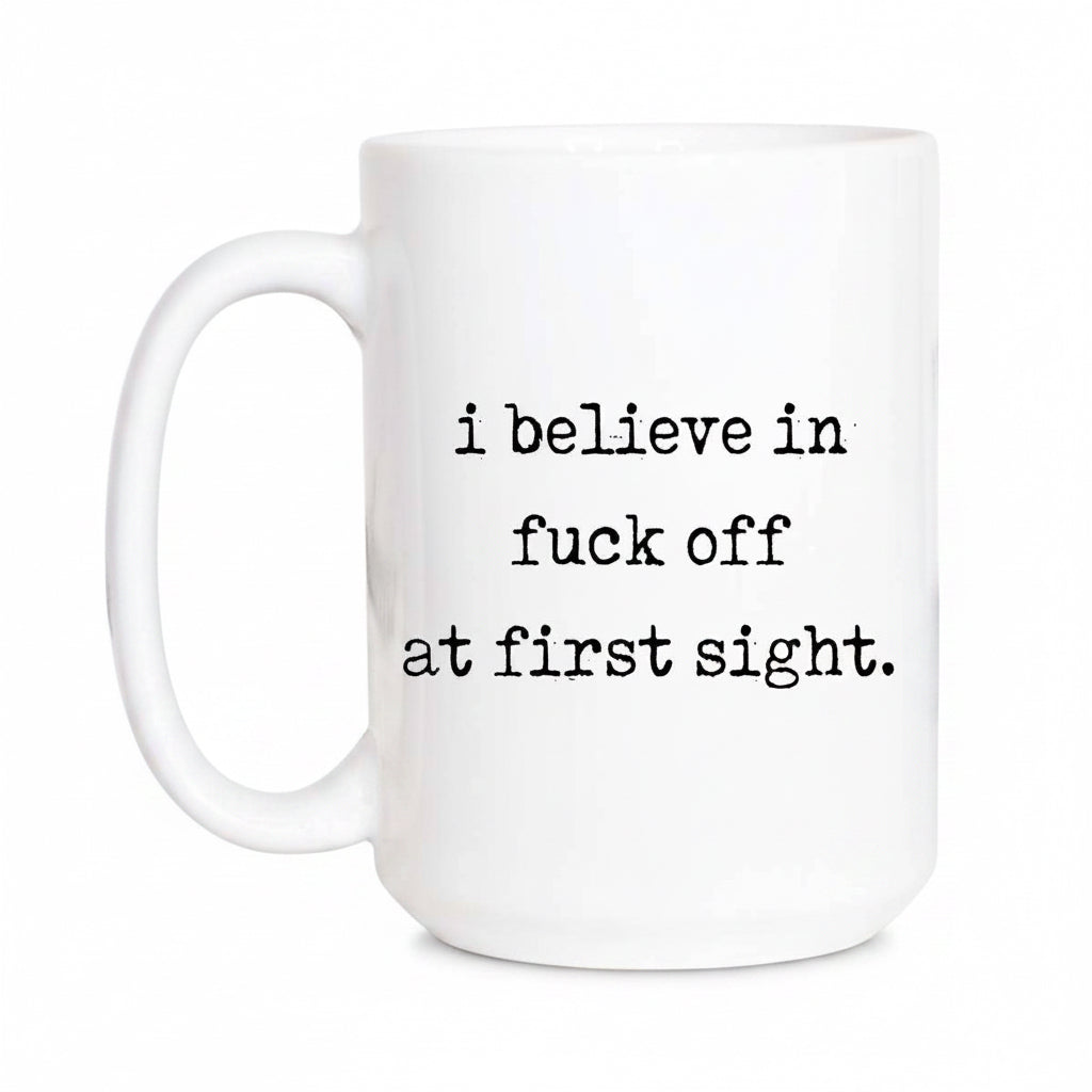 White mug with black text 'i believe in fuck off at first sight' on a white background