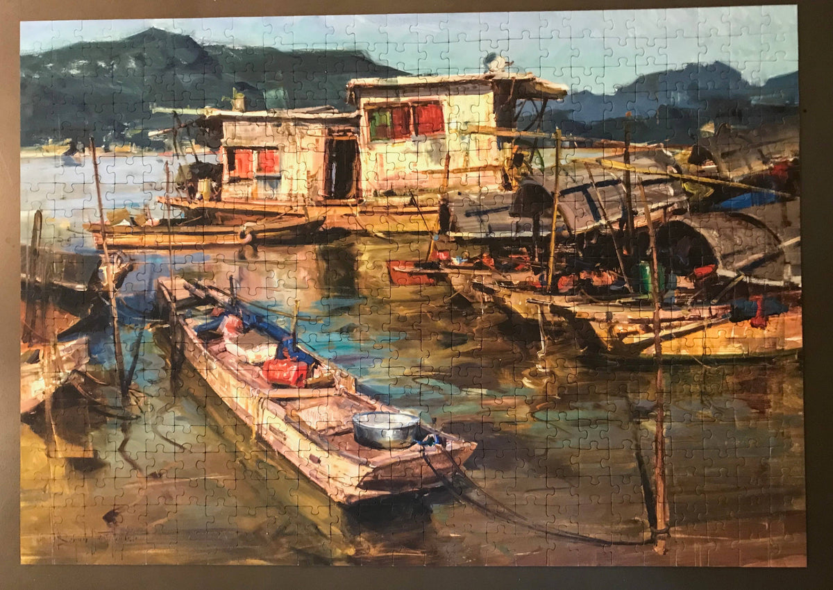Painting in puzzle form of a dock with boats and houses on stilts over water