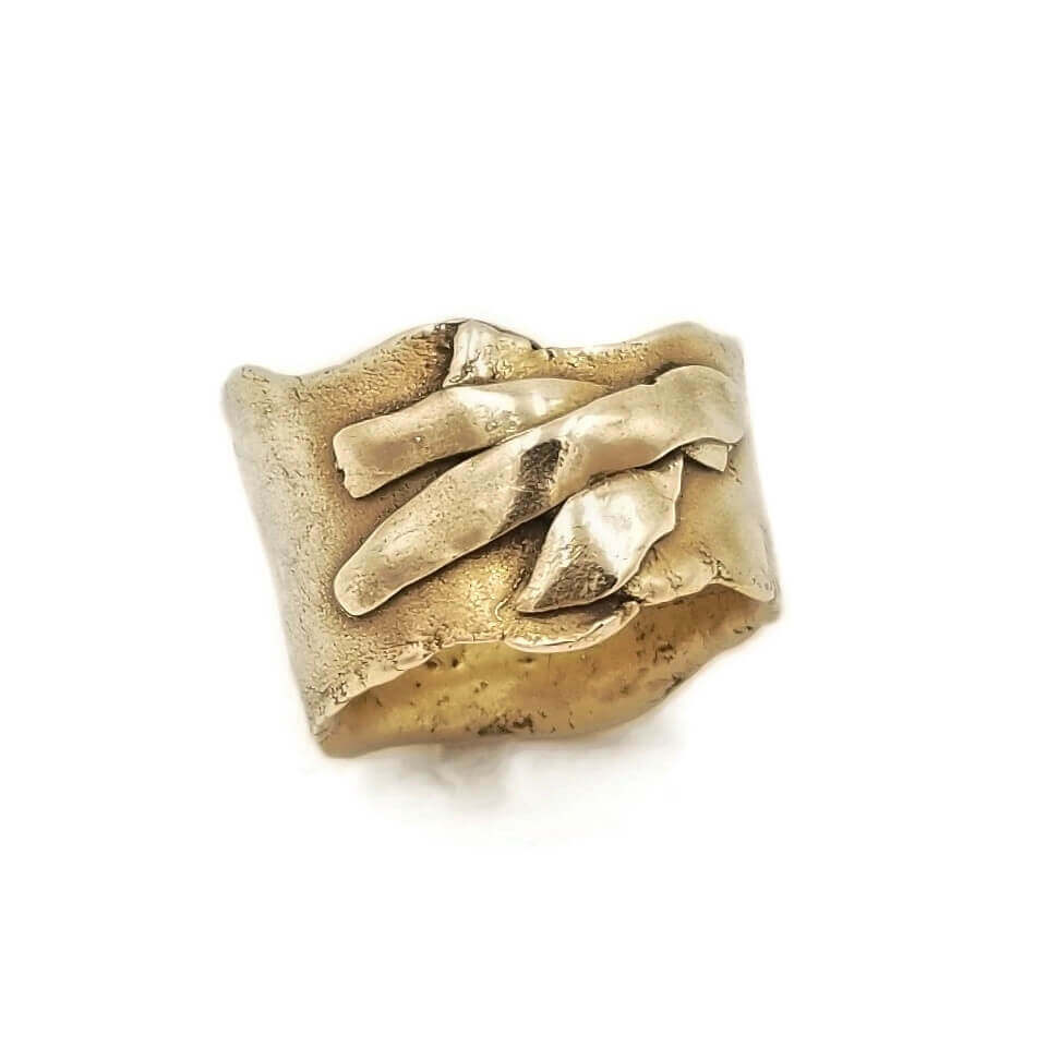 Irregular edge, wide band bronze ring with 3 flattened rectilinear but irregular accents across the top. Made by artist Cristine Grimm