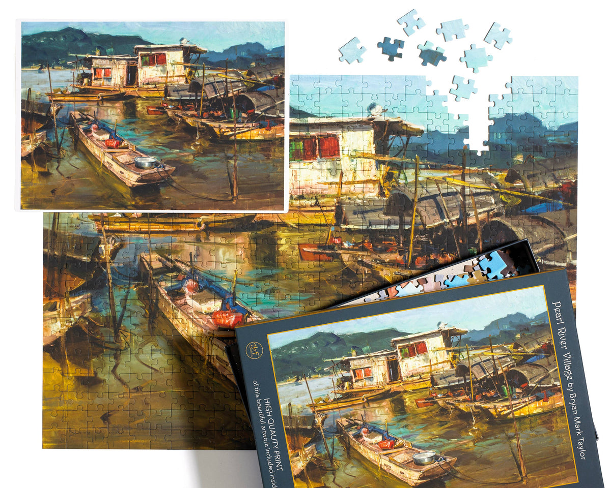 Jigsaw puzzle of a village scene with boats and houses, showing completed pieces and packaging.
