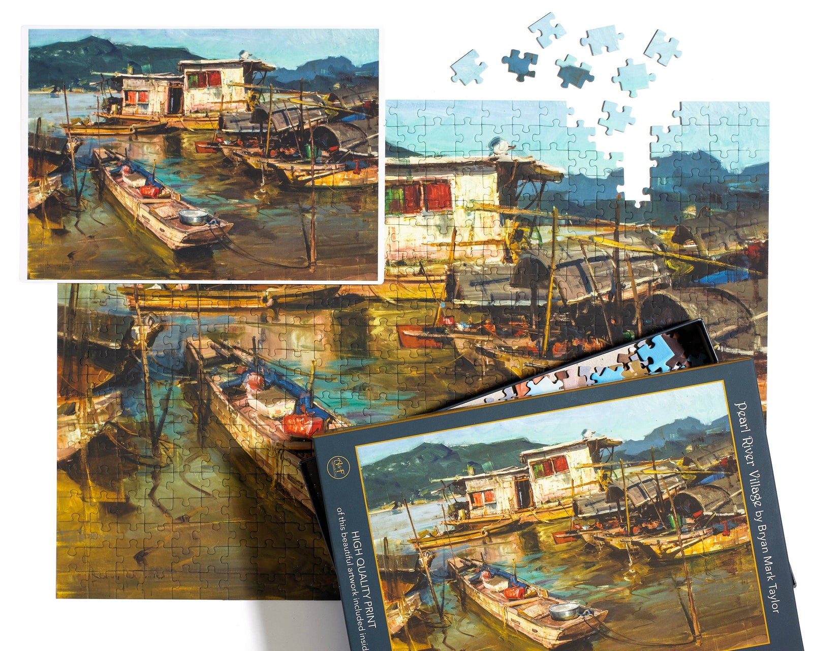 Art print puzzle packaging with a scenic depiction of boats and houses on a lake.