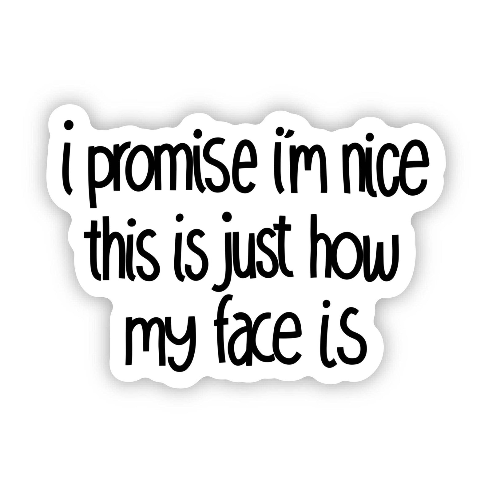 Hand holding a sticker with text 'I promise I'm nice this is just how my face is' against a neutral background.