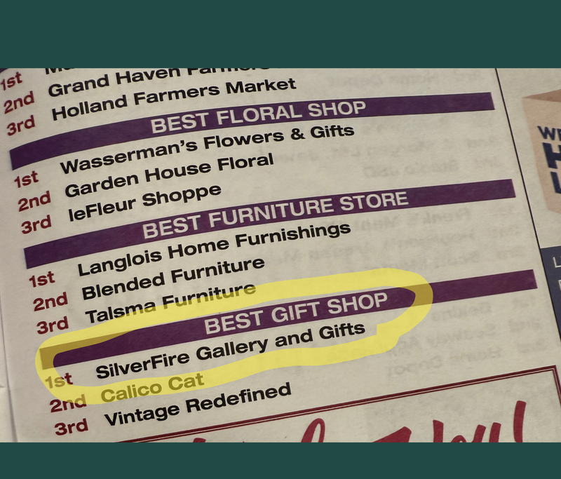 A close-up of a printed list with purple headings and text, including 'BEST FLORAL SHOP,' 'BEST FURNITURE STORE,' and 'BEST GIFT SHOP,' with 'BEST GIFT SHOP' highlighted in yellow. The photo is cropped and includes a dark teal border around it.