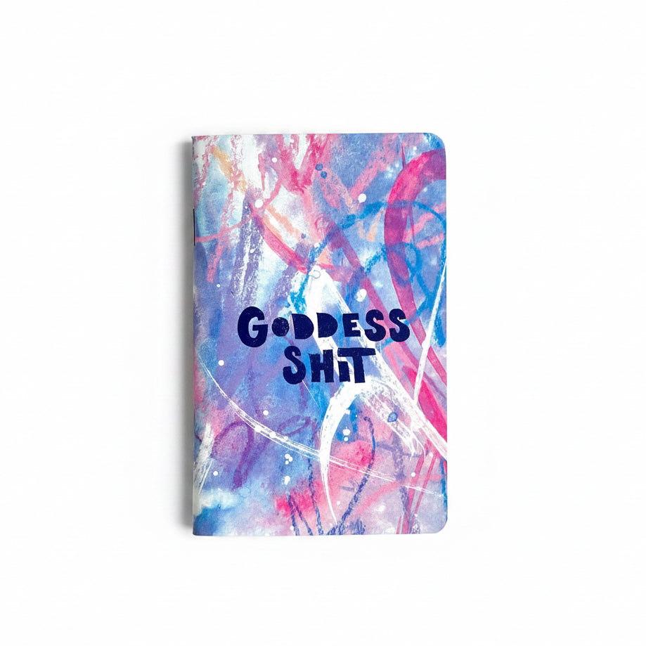 Notebook with colorful abstract design and 'GODDESS SHIT' text on cover.