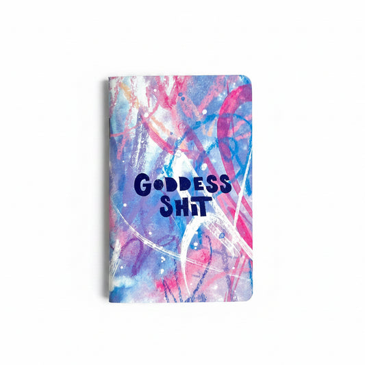 Notebook with colorful abstract design and 'GODDESS SHIT' text on cover.