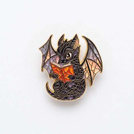A black dragon with purple and peach wings holding an orange book.