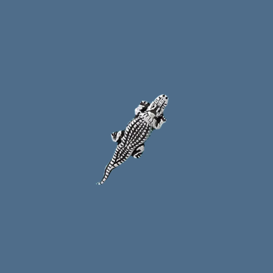 Pewter crocodile on a blue background