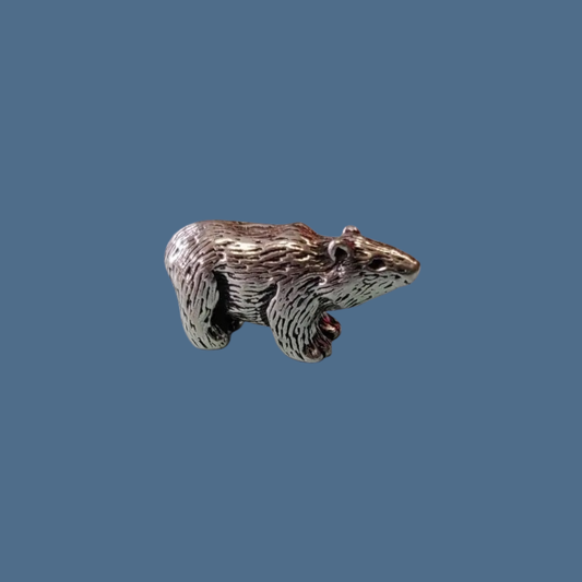 Metallic bear figurine on a blue background