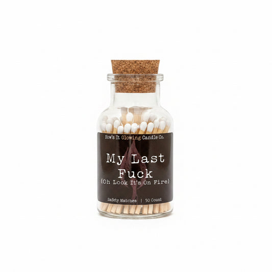 Matches in a glass bottle with a humorous label on a white background