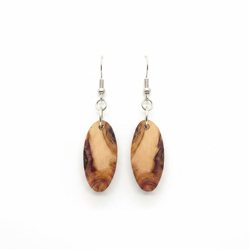 A pair of handmade dangle earrings with oval brown and beige wood-grain pendants on silver ear wires.
