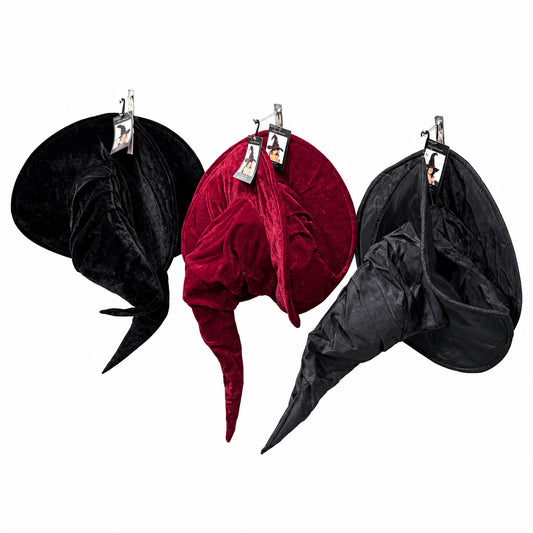 Three velvet witch hats in black velvet, burgundy red velvet, and black satin are displayed on metal hooks. 