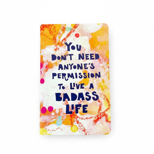 Colorful notebook with motivational quote on a white background