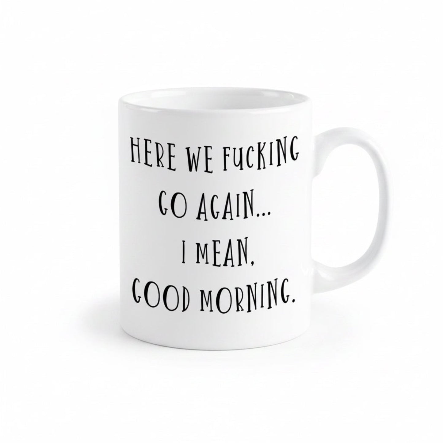 A white ceramic mug with black text printed on it.
