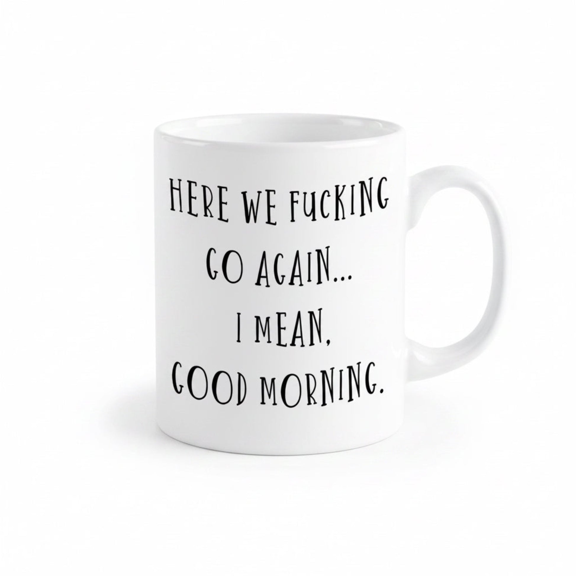 A white ceramic mug with black text printed on it.