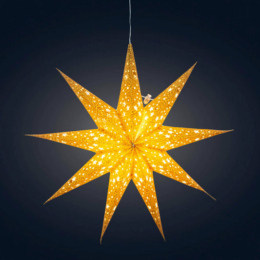 A gold and white star-shaped decorative light with gold glitter, hanging against a dark background.