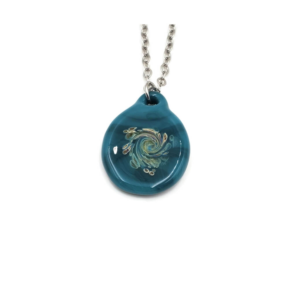 Turquoise pendant hanging on a silver tone chain. The pendant features swirling colors of sage green and creamy yellow.