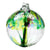 A large clear blown glass ornament whose main color is green with accents of yellow, light blue, and purple. Webs of glass stretch across the inside of the orb.