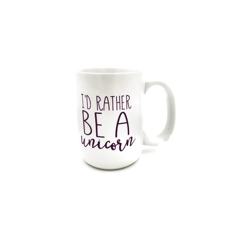 White ceramic mug with purple lettering reading &quot;I&#39;d Rather be a Unicorn&quot;.