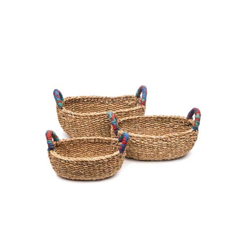 Set of three woven table baskets handcrafted with brightly colored, recycled sari wrapped handles. 